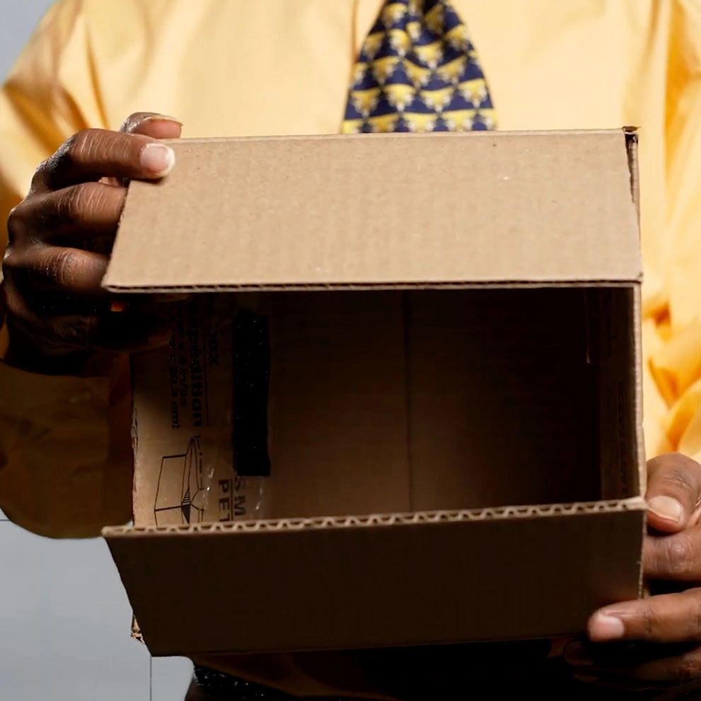 A man holding an open cardboard box