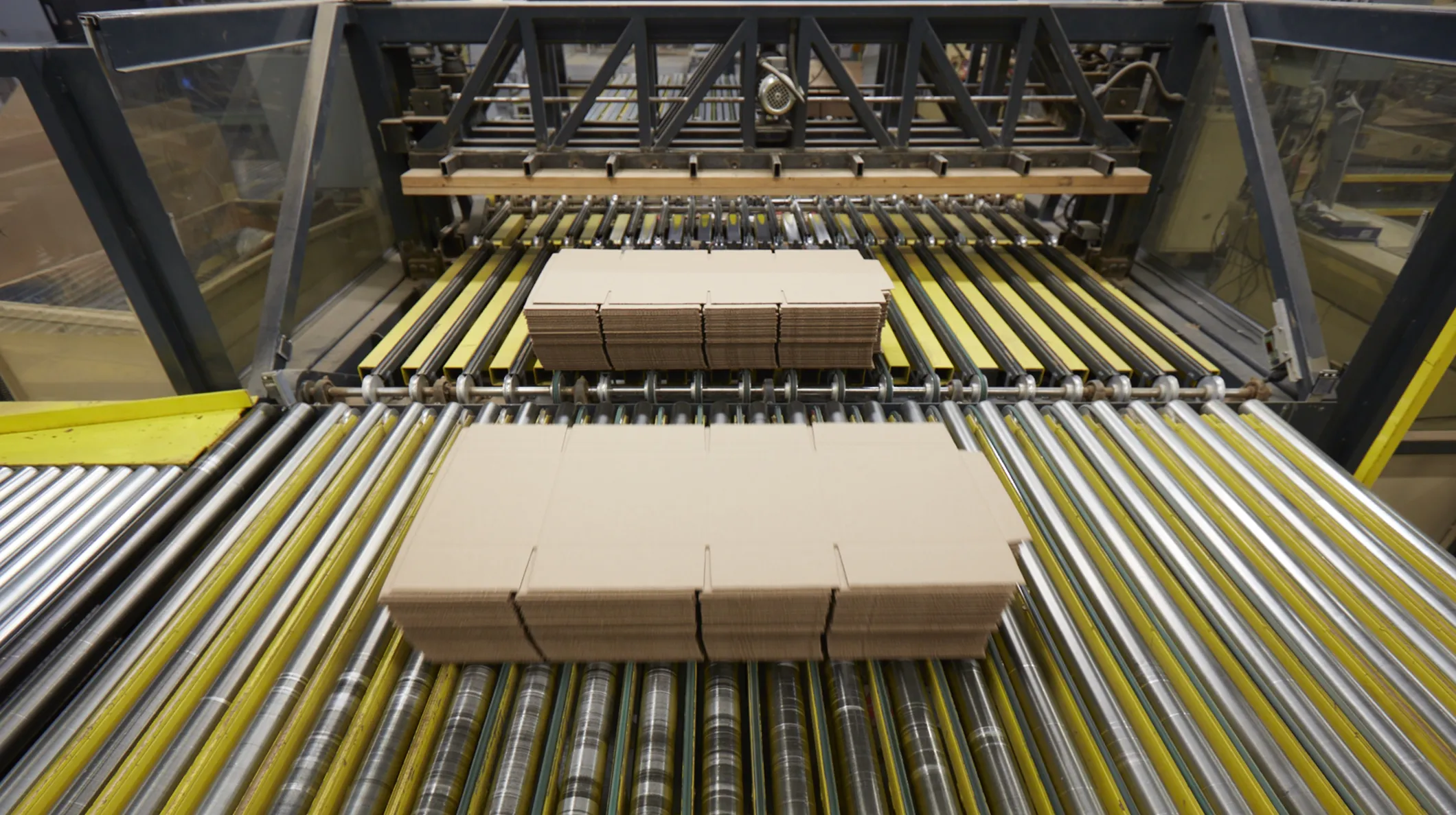 Corrugated cardboard sheets moving through a production line
